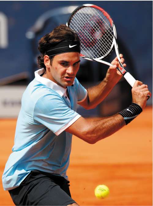 Roger Federer hits a return to Robin Soderling during his 6-3, 6-2 win in Hamburg yesterday