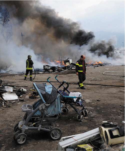 The remains of the camp set on fire on Wednesday as local people watched and applauded