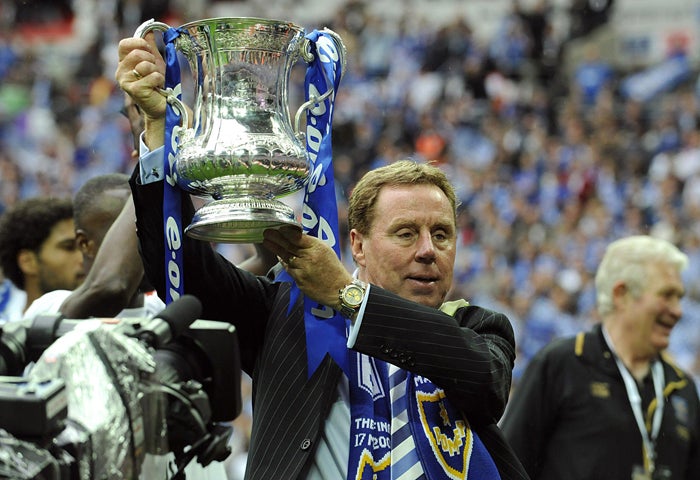 Portsmouth manager Harry Redknapp lifts the FA Cup at Wembley. He admitted it had been a tough year 'off the field... but winning here is a dream come true'