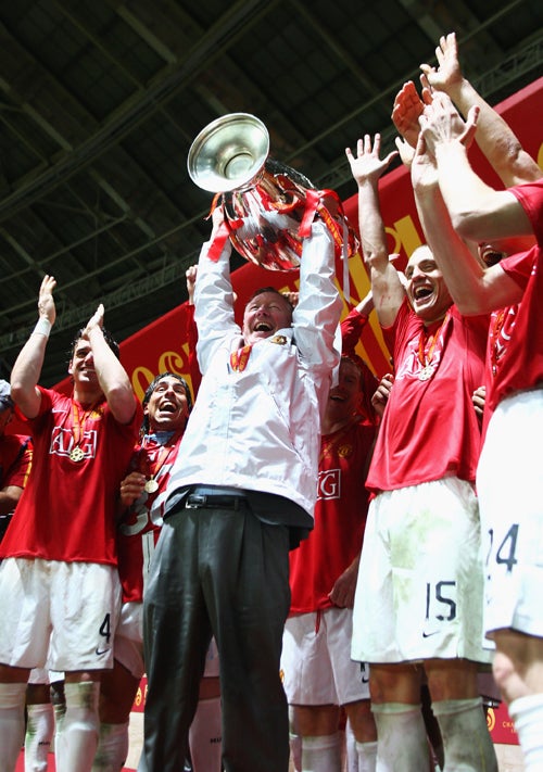 The Manchester United manager, Sir Alex Ferguson, lifts the European Cup after beating Chelsea