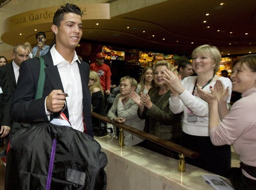 Cristiano Ronaldo checks out of Manchester United's hotel in Moscow yesterday