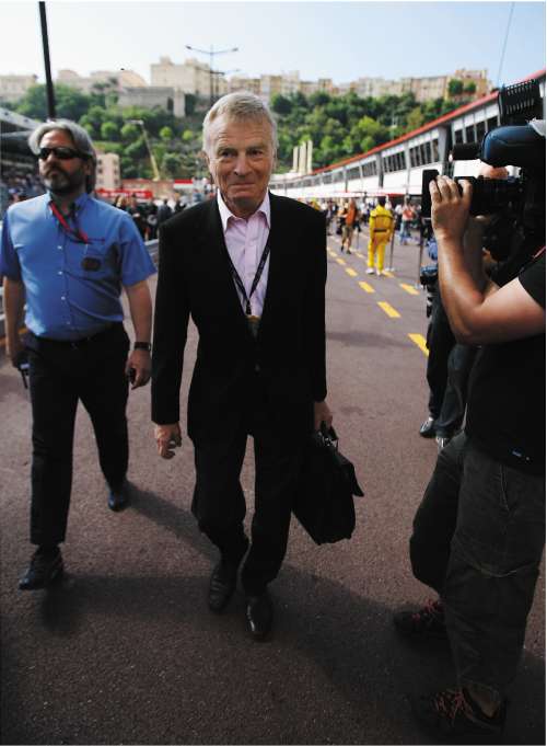 Max Mosley is the focus of the media as he walks through the pit lane in Monaco yesterday