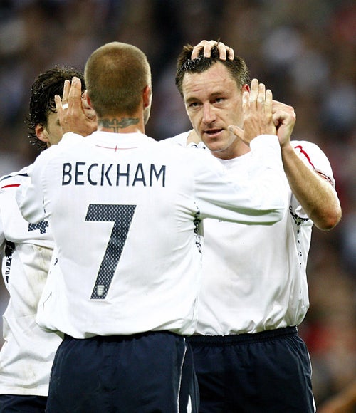 David Beckham congratulates John Terry on scoring England's first goal against the US at Wembley, having provided the cross which the defender headed home