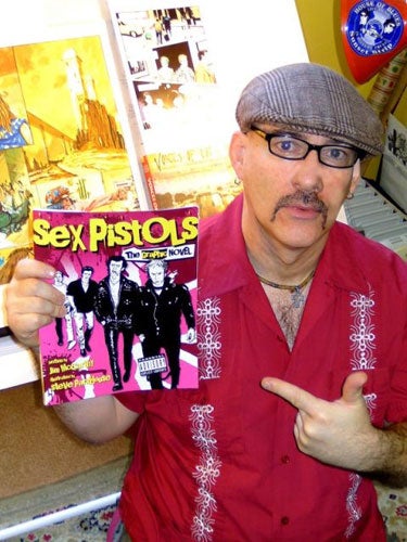 Comic artist Jim McCarthy with his book, Sex Pistols