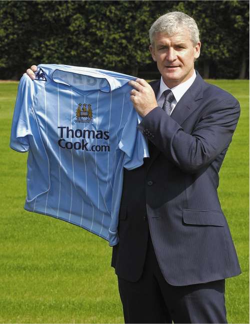 Hughes arrives at Manchester City yesterday