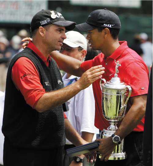 Woods collects the US Open trophy and embraces runner up Rocco Mediate