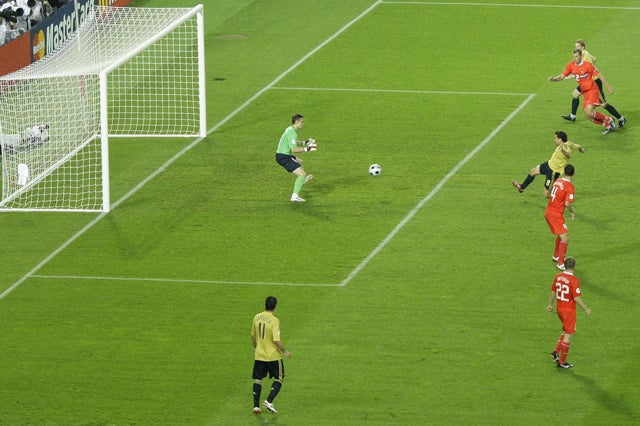Xavi scores the opening goal in Vienna last night, latching on to Andres Iniesta's cross