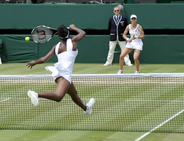 Venus Williams goes to the net to make a return in the straight-sets victory over Elena Dementieva that secured her a seventh Wimbledon singles final