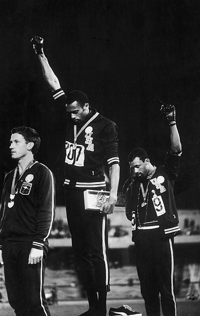 Peter Norman, left, stood proudly alongside his fellow athletes, supporting their protest.
