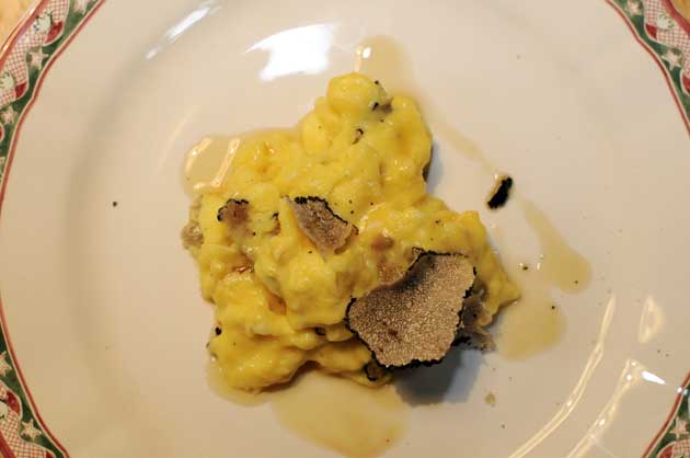Divide the eggs among four plates and shave a little truffle over each