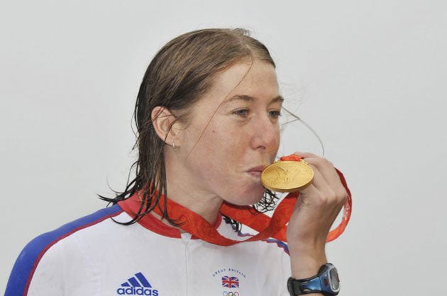 Nicole cooke of Britain kisses her gold medal after winning the woman's road race in Beijing