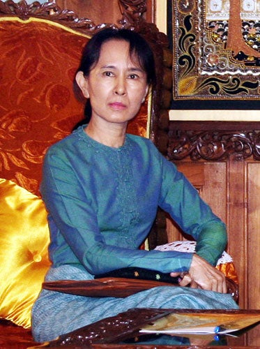 Aung San Suu Kyi said she did not violate her house arrest by admitting a man who swam to her lakeside home