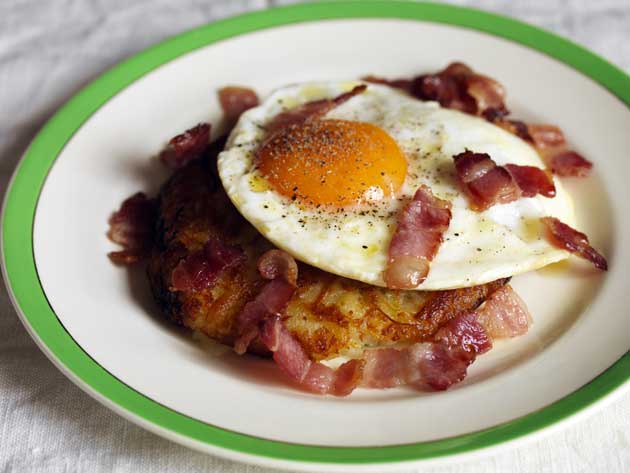 Serve the eggs on the rosti with the bacon scattered over