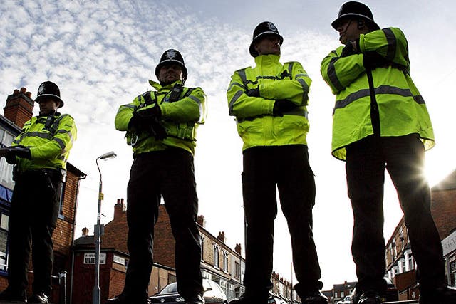 Police officers guard a Birmingham road after anti-terror arrests in 2007