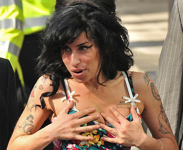 Singer Amy Winehouse was divorced by her estranged husband today on the grounds of her adultery.