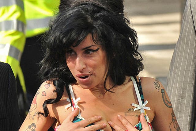 Singer Amy Winehouse was divorced by her estranged husband today on the grounds of her adultery.