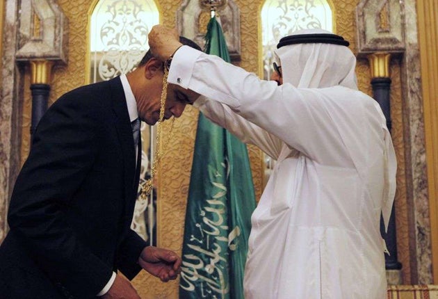 President Barack Obama is presented with a gift from King Abdullah