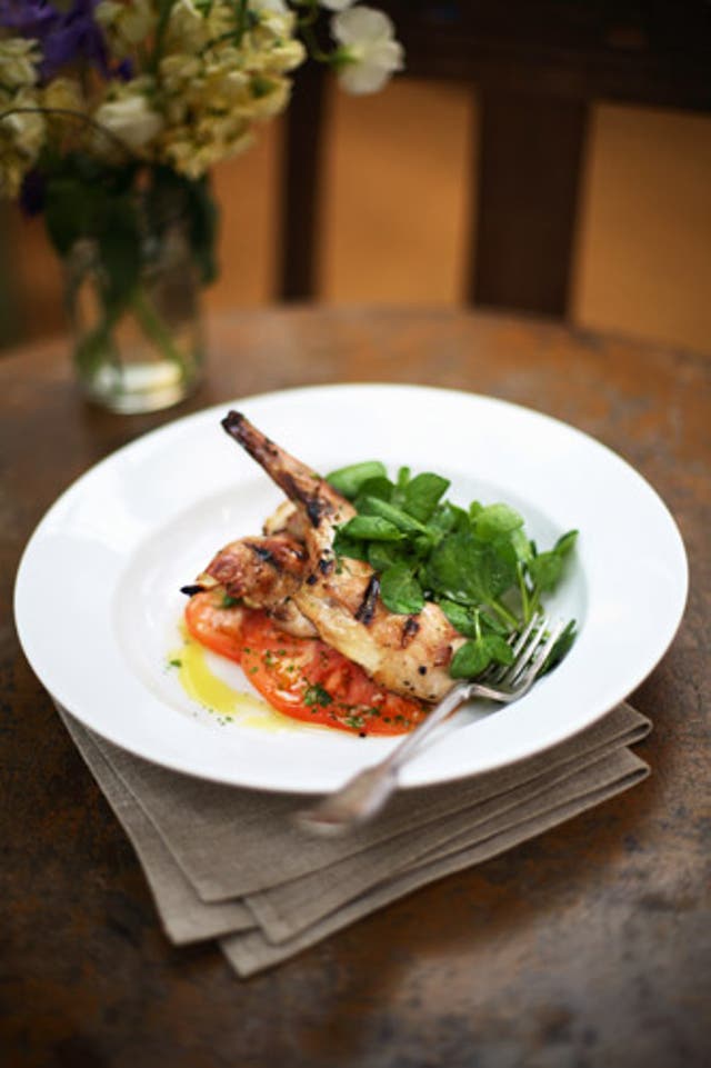 The rabbit is cooked quickly over a grill and served with zingy basil and juicy tomatoes