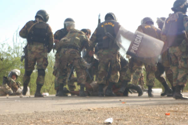 Police appearing to beat a man at Bagua in 2009