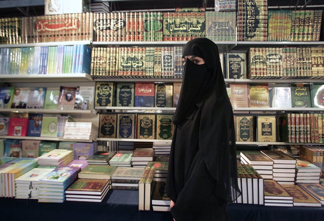A woman wears a burqa in the suburbs of Paris.