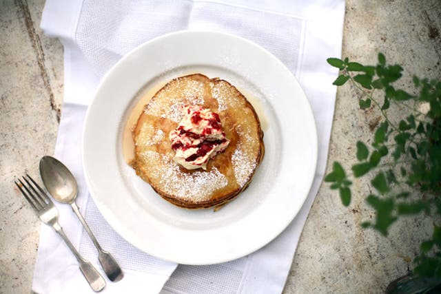 Serve the pancakes hot from the pan with raspberry butter and maple syrup
