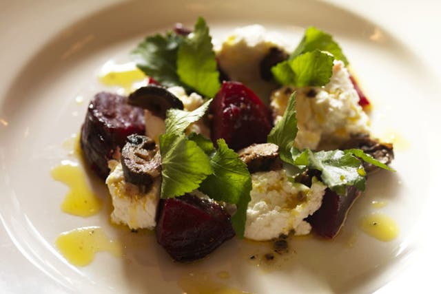 Arrange the beetroot, goat's curd or goat's cheese and the salad leaves in serving bowls or plates, season lightly and spoon over the dressing