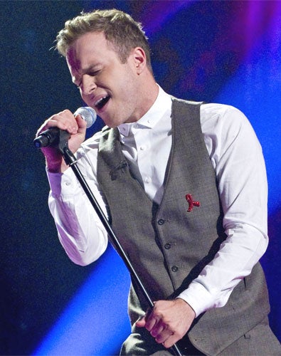 X Factor runner-up Olly Murs signed a record deal today which will see him working jointly with Simon Cowell's label.