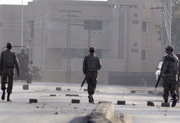 Pakistani troops inspect the debris after suicide bombers and gunmen killed 40 people in a Rawalpindi mosque