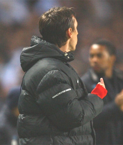 Gary Neville was warned by the FA for baiting Liverpool fans and taunting City supporters, but was still let off the hook for his gesture at Carlos Tevez (above)