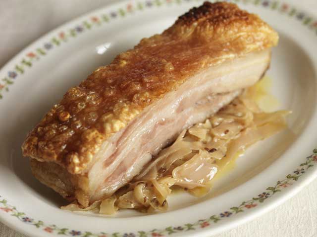 Slice the pork belly or leave it as a chunk, spoon the cabbage on to warmed plates and lay the pork on top