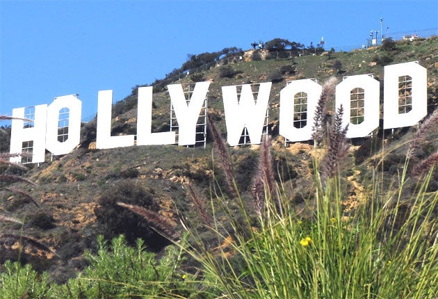 The Hollywood sign has been spared from urban sprawl and will stand unobscured to welcome future actors, writers and Austrian bodybuilders, California governor Arnold Schwarzenegger said.