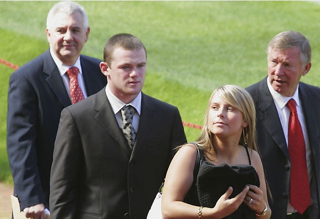 September 2004: Paul Stretford (left) with Wayne Rooney, Coleen McLoughlin and Sir Alex Ferguson after Rooney's signing at Manchester United