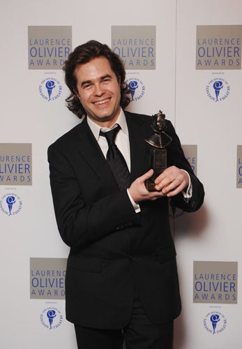 Rupert Goold poses with his Best Director award for 'Enron