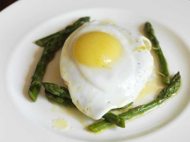 Place the duck eggs on the crumpets and scatter the buttered asparagus over