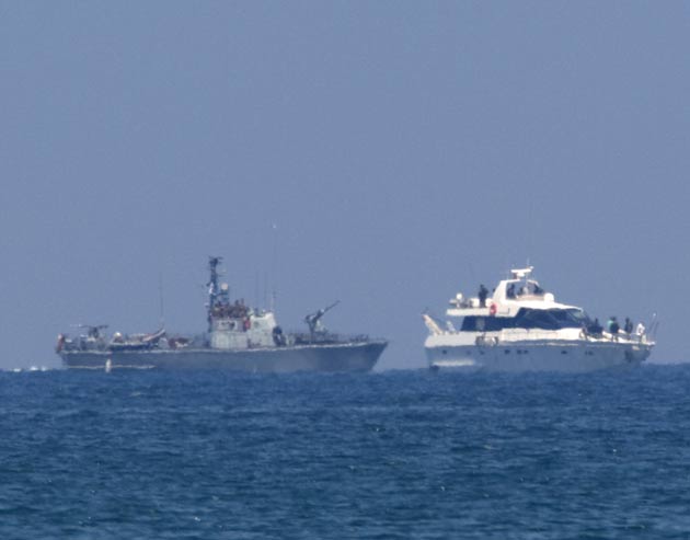This 2010 images shows an Israeli army military vessel (L) escorting one of the boats in the last ill-fated Gaza-bound aid flotilla
