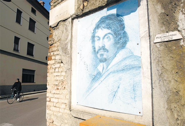 A painting of Caravaggio on a wall near the house where he was born in the northern Italian town in Lombardy of the same name