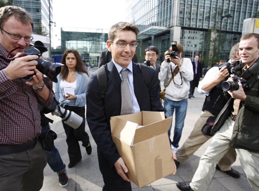 A man carries a box from Lehman Brothers' offices in London after the bank failed in 2008
