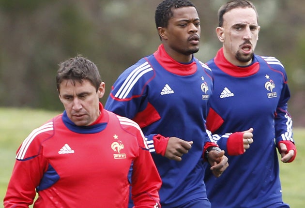 Patrice Evra (centre) and Franck Ribery run past fitness coach Robert Duverne during a training session at France's ill-fated World Cup