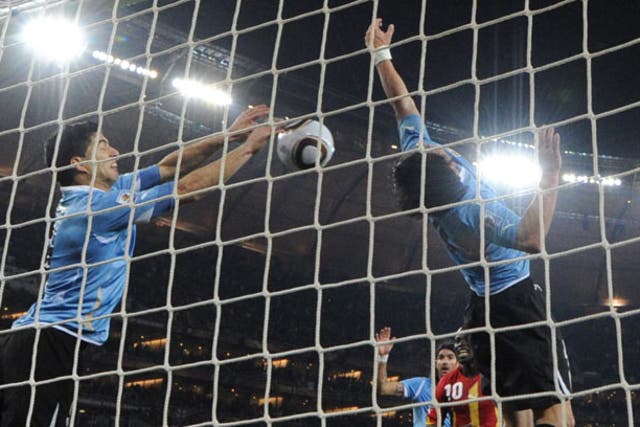 <p>Luis Suarez saves a shot with his hands which would have sent Ghana to the World Cup semi-finals </p>