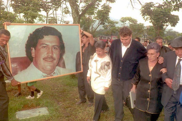 <p>Hermilda de Escobar, mother of Medellin drug cartel kingpin Pablo Escobar, walks with friends and relatives to Escobar’s tomb for the first anniversary of his death</p>