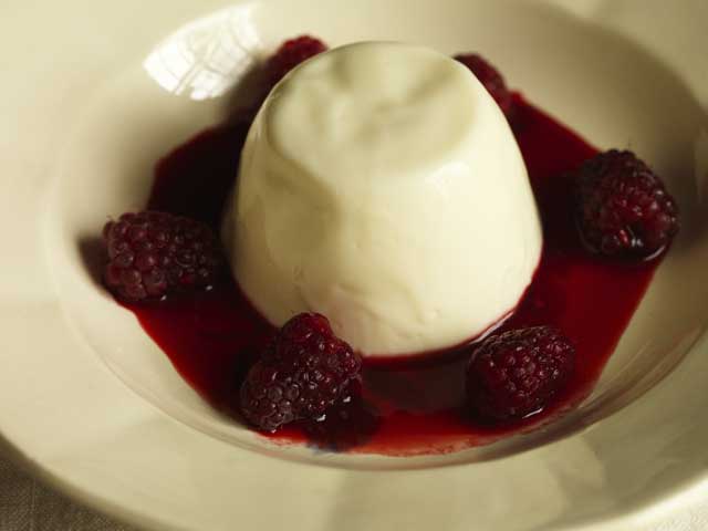 To serve, scatter the Tayberries around the puddings and spoon around the syrup