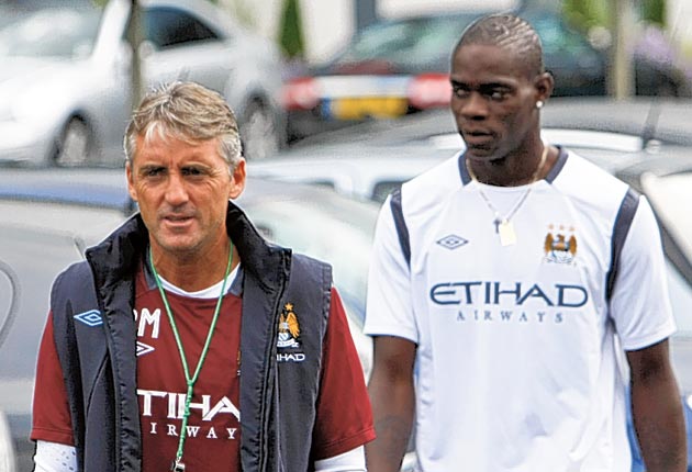 Mancini pictures with Balotelli shortly after his arrival at City