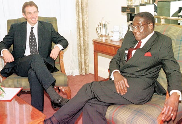 <p>Former prime minister Tony Blair speaks with ex-Zimbabwe president Robert Mugabe</p>