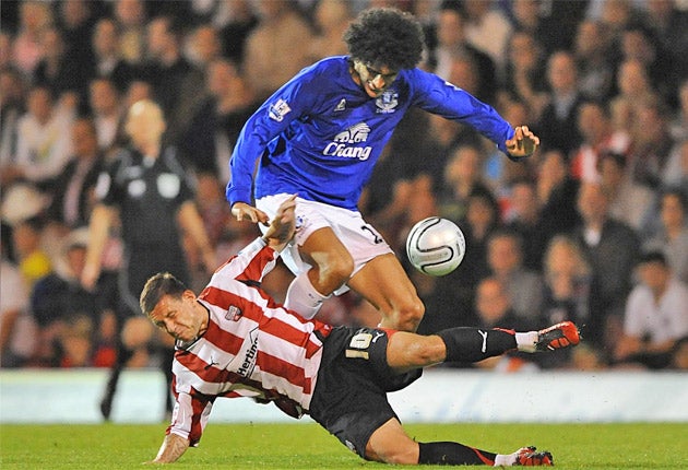 Marouane Fellaini and Brentford's Charlie MacDonald battle for the ball during tonight's Carling Cup encounter