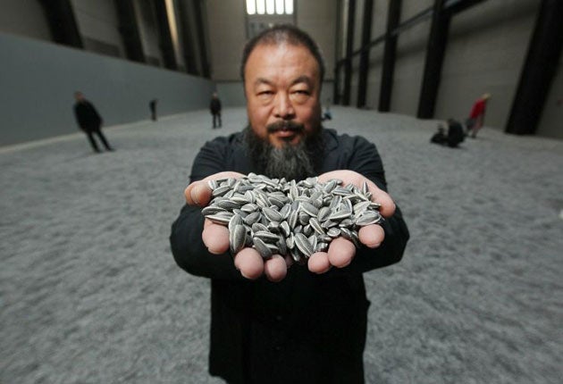 Ai Wei Wei with his installation, Sunflower Seeds, currently showing at Tate Modern