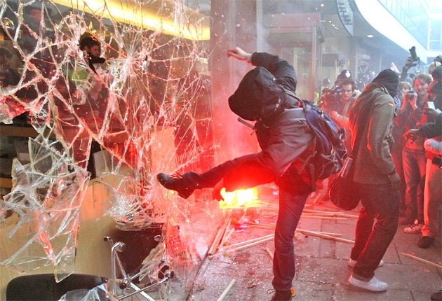 This photo of a student kicking a window at Millbank Tower became a symbol of the protests but was criticised as misrepresentative by thousands of peaceful demonstrators