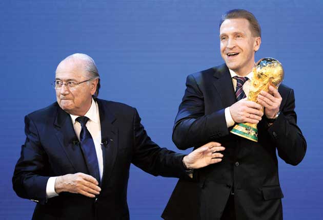 Russia’s Deputy Prime Minister, Igor Shuvalov, takes the World Cup from the Fifa president, Sepp Blatter.