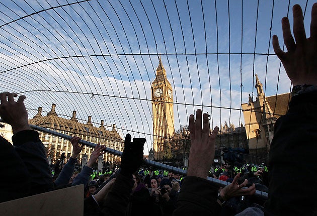 Student fees protesters raise a fence in Parliament Square on 9 December 2010