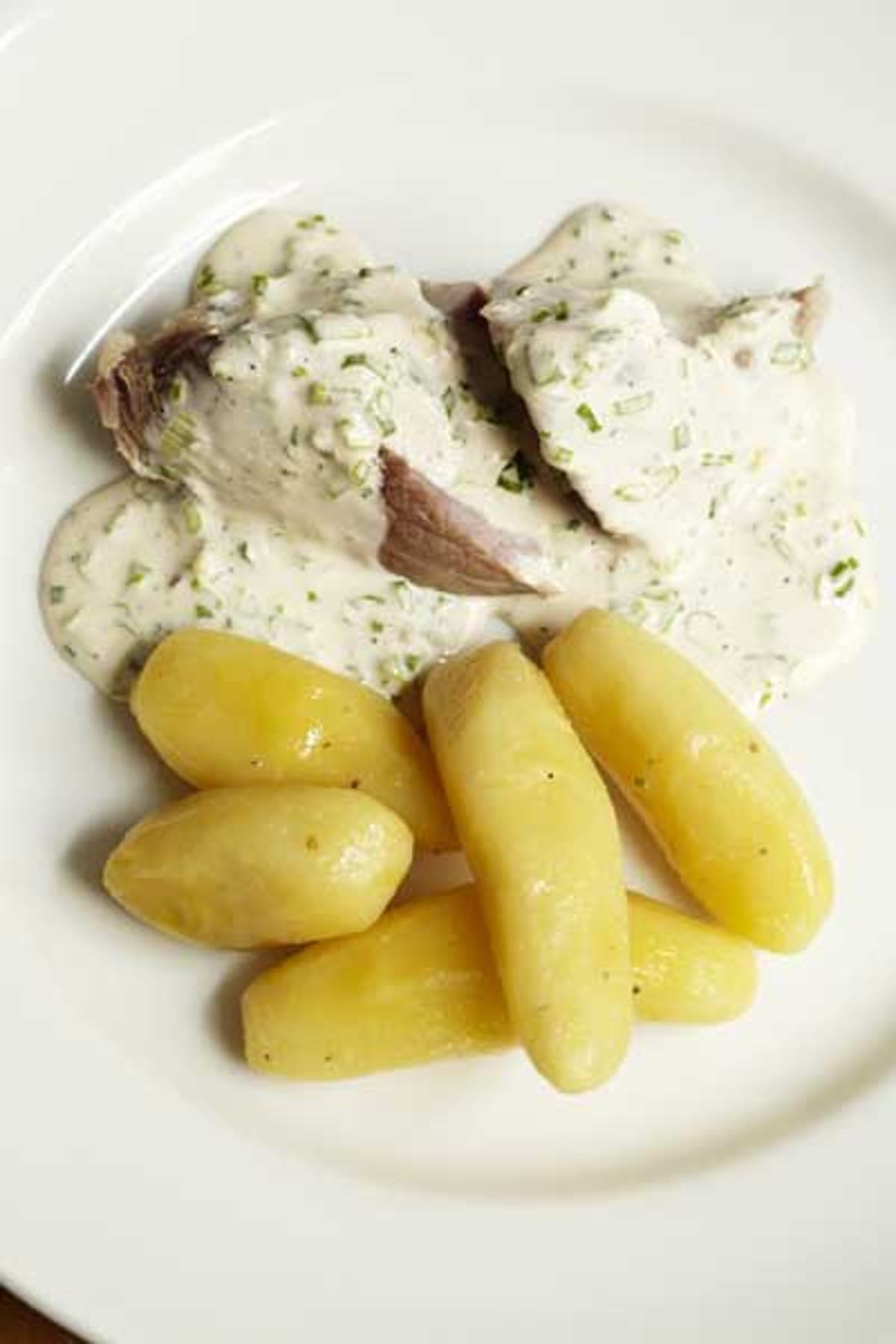 Ham hock cooked in cider with potatoes and green onion sauce