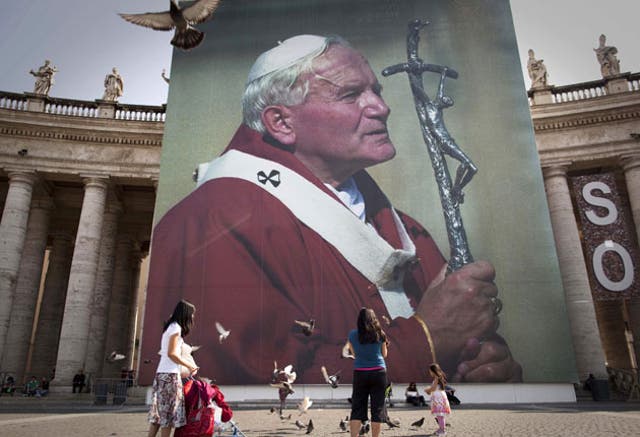A photo of the late Pope John Paul II hanging from a stage set up near St Peter's Square